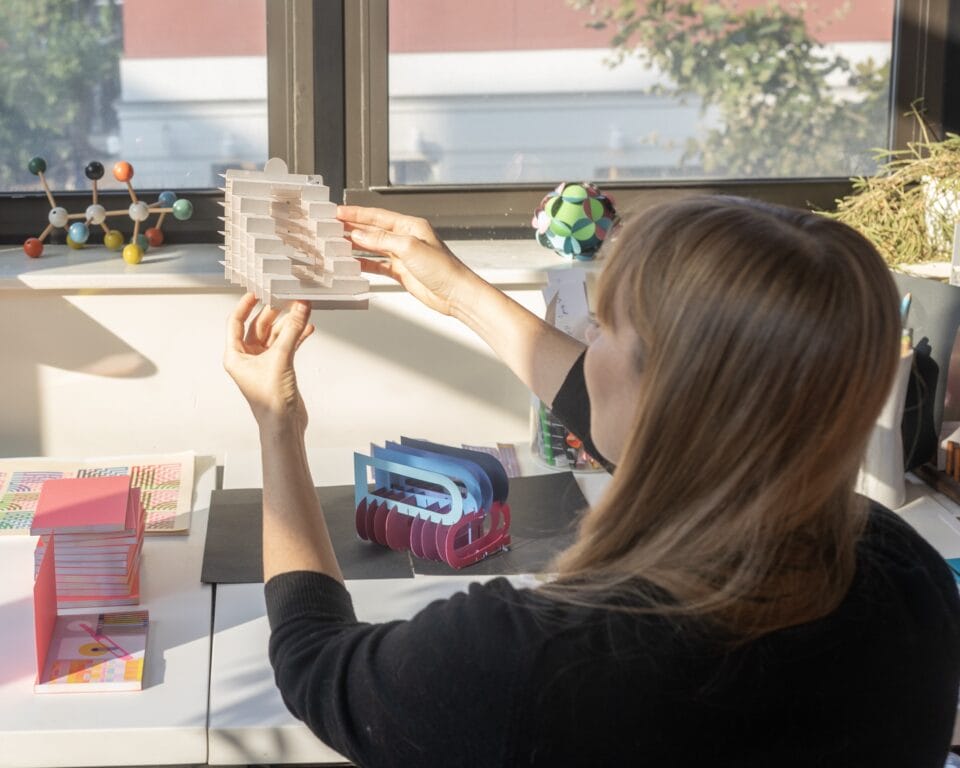 designer Kelli Anderson working on a paper pop-up for her book 'Alphabet in Motion' about letter form